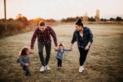 Kids plaing in meadow with parents Kids plaing in meadow with parents