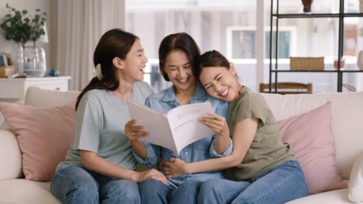 Buy mediclaim health care life insure for older mum. Young adult woman asia people grown up child give gift to middle aged mom reading protect cover saving plan paper smile laugh sitting at sofa home. Buy mediclaim health care life insure for older mum. Young adult woman asia people grown up child give gift to middle aged mom reading protect cover saving plan paper smile laugh sitting at sofa home.
